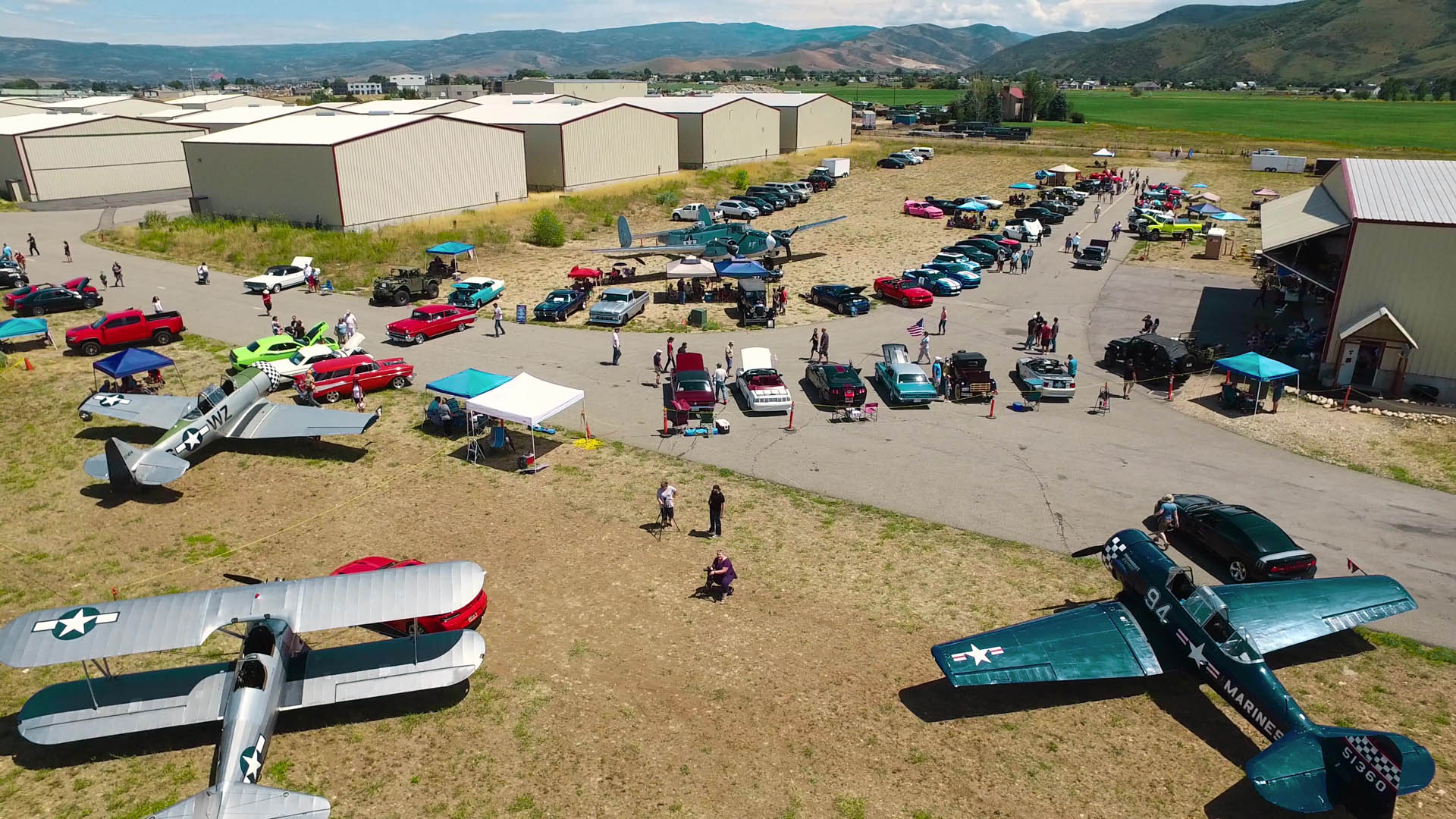 Aerial shot of vintage cars and airplanes at Heber Airport